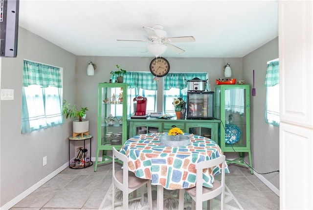 dining space with ceiling fan and light tile patterned floors