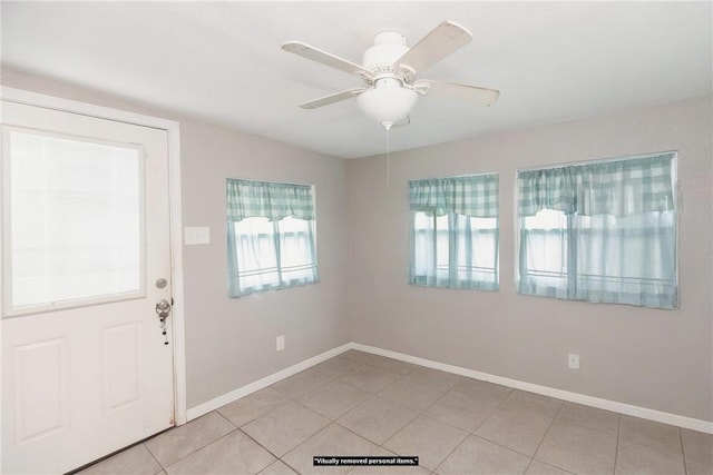 foyer featuring ceiling fan and light tile patterned floors