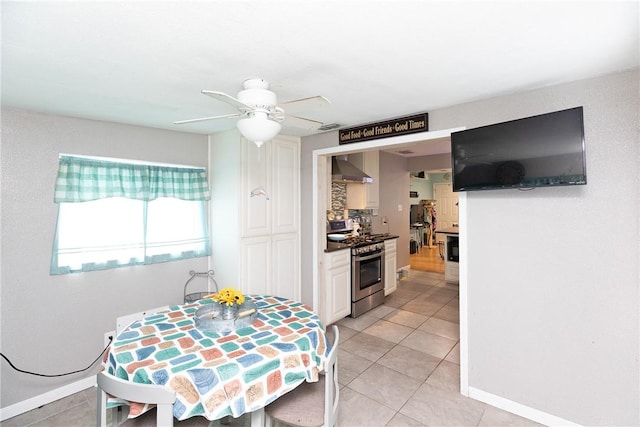 tiled dining area featuring ceiling fan