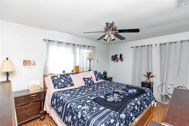 bedroom with parquet floors and ceiling fan