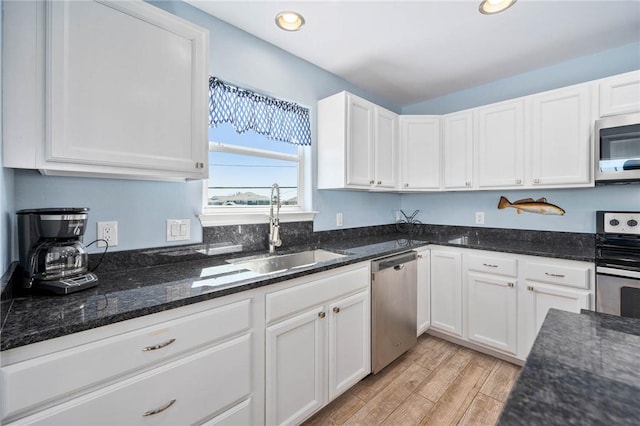 kitchen with white cabinets, stainless steel appliances, and a sink