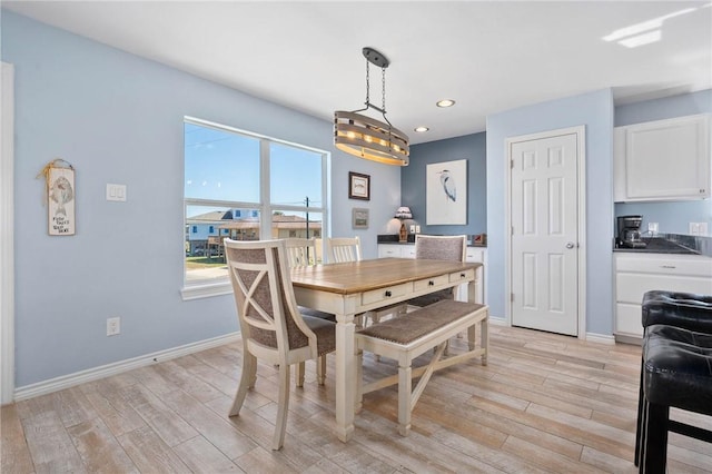 dining room with baseboards, recessed lighting, and light wood-style floors