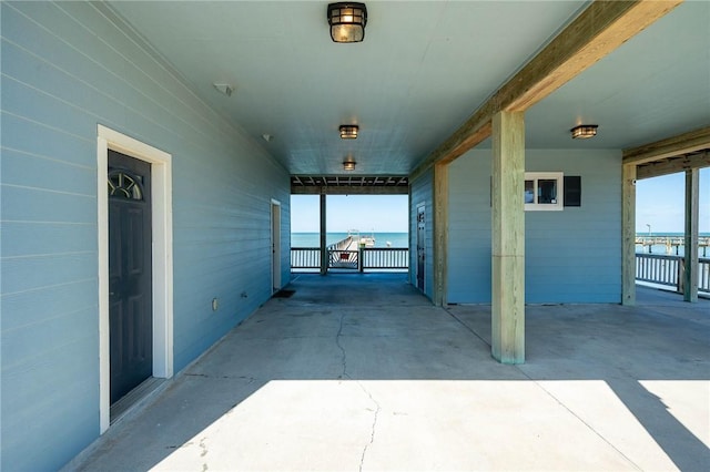 view of patio / terrace with a water view and a carport