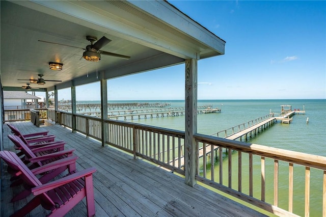 wooden deck featuring a water view and ceiling fan