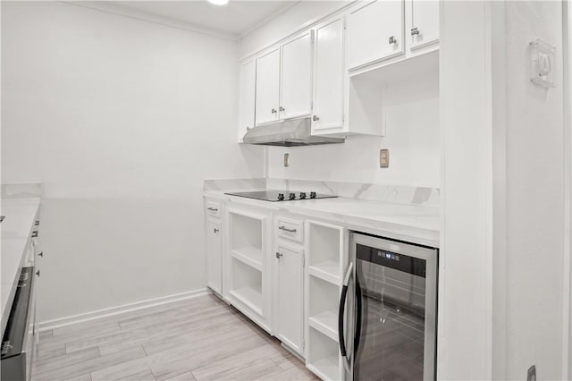 kitchen with white cabinets, black electric cooktop, light hardwood / wood-style floors, and wine cooler