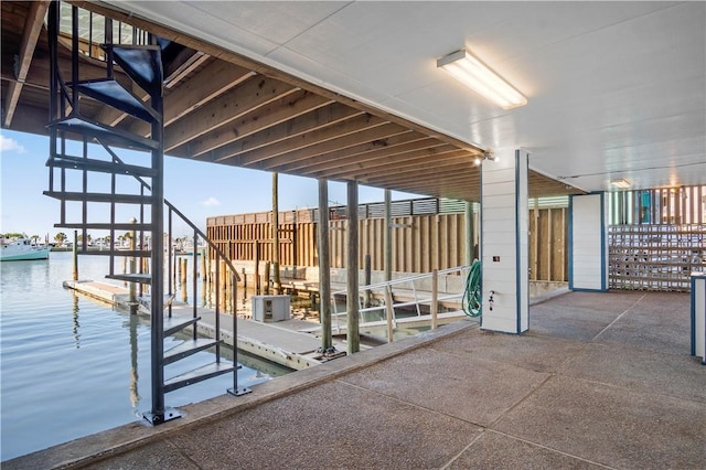 view of patio featuring a boat dock and a water view