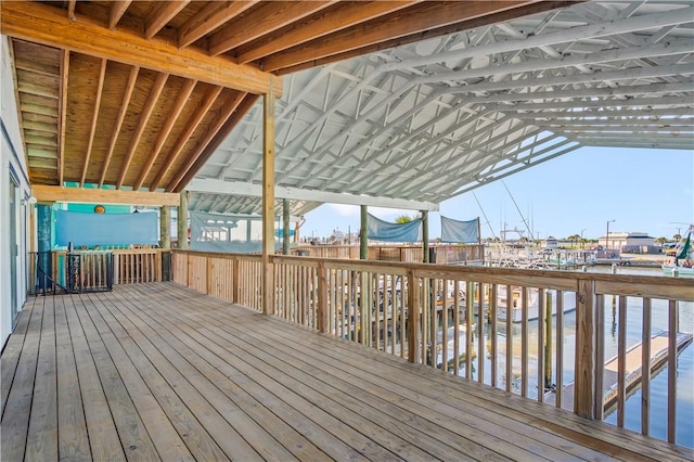 wooden terrace with a trampoline and a water view