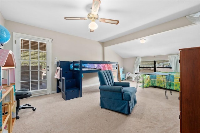 carpeted bedroom with lofted ceiling, access to exterior, multiple windows, and ceiling fan