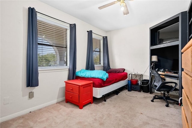 carpeted bedroom featuring baseboards and ceiling fan