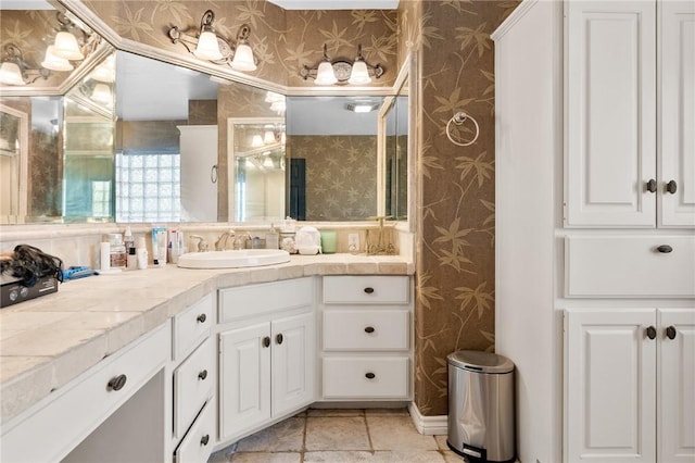 bathroom with wallpapered walls and vanity