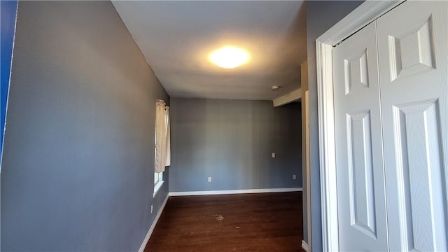 hall with dark hardwood / wood-style flooring and a textured ceiling