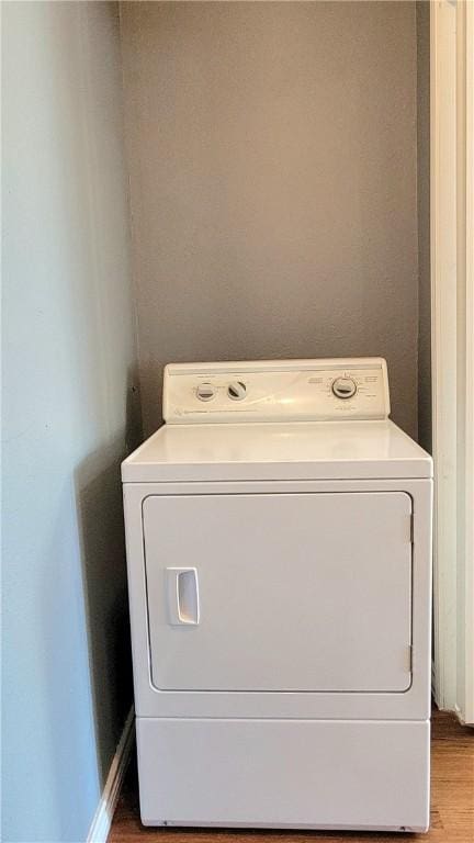 laundry room with light hardwood / wood-style floors and washer / dryer