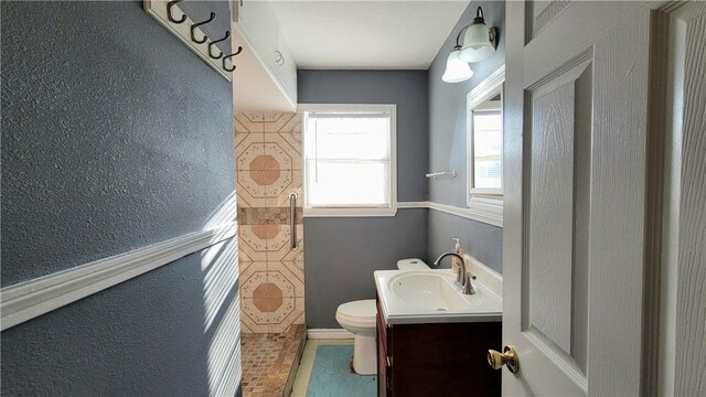 bathroom featuring tile patterned floors, vanity, and toilet