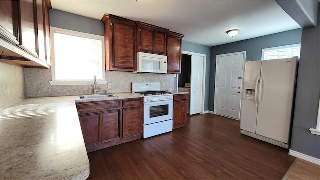 kitchen with white appliances, dark hardwood / wood-style floors, tasteful backsplash, and sink