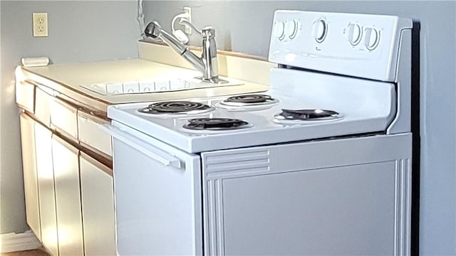 kitchen featuring white cabinets and electric stove