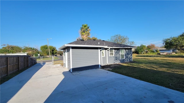 rear view of house featuring a lawn and a patio area