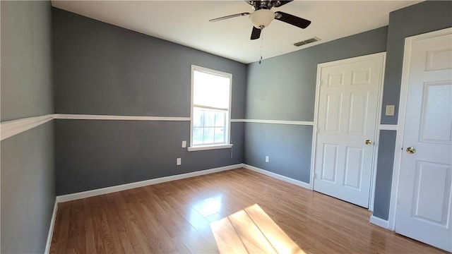 empty room featuring light hardwood / wood-style flooring and ceiling fan