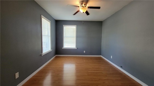 empty room featuring wood-type flooring and ceiling fan