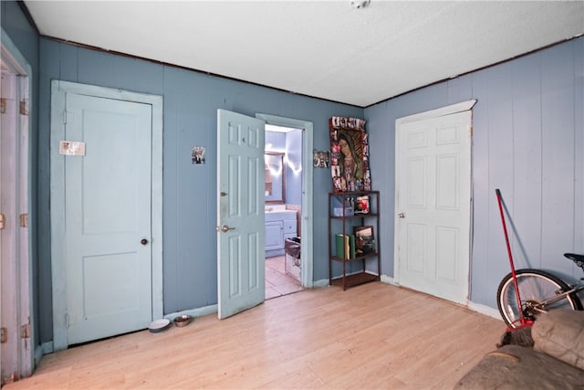 interior space featuring wooden walls and light wood-type flooring