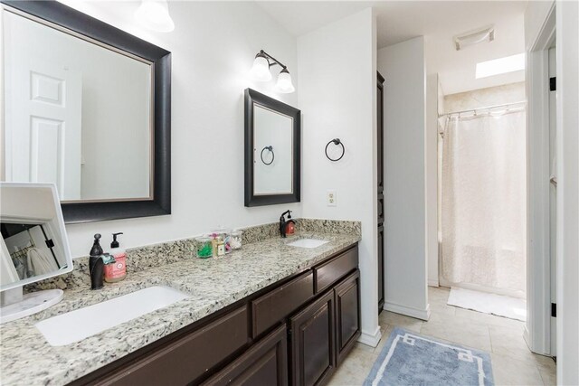 14605 Reagan Dr, Corpus Christi, TX 78410 - full bath with double vanity, tile patterned floors, and curtained shower