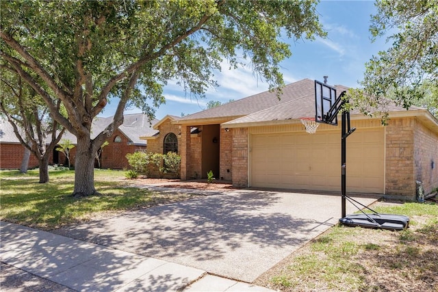 14605 Reagan Dr, Corpus Christi, TX 78410 - view of front of property with brick siding, driveway, an attached garage, and a shingled roof