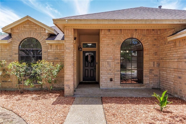 14605 Reagan Dr, Corpus Christi, TX 78410 - doorway to property featuring a shingled roof and brick siding