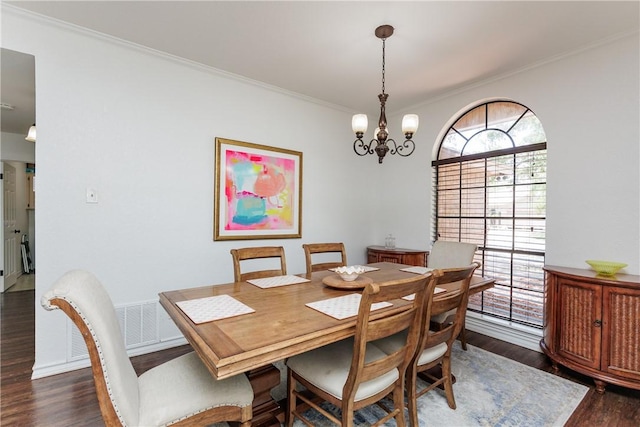 14605 Reagan Dr, Corpus Christi, TX 78410 - dining area with dark wood-style floors, ornamental molding, and a chandelier