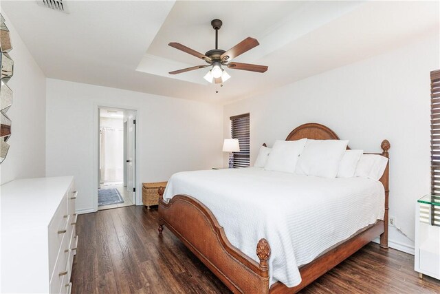 14605 Reagan Dr, Corpus Christi, TX 78410 - bedroom featuring wood finished floors, a raised ceiling, a ceiling fan, and connected bathroom