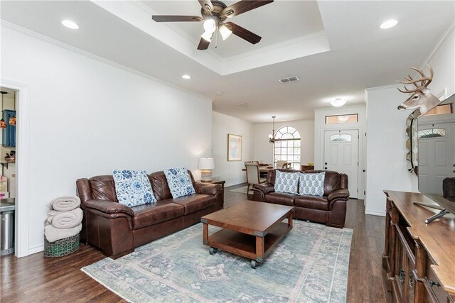 14605 Reagan Dr, Corpus Christi, TX 78410 - living room featuring dark wood-style flooring, a ceiling fan, a raised ceiling, ornamental molding, and a chandelier