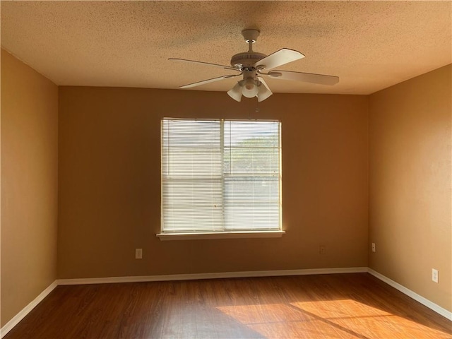 empty room with hardwood / wood-style flooring, ceiling fan, and a textured ceiling