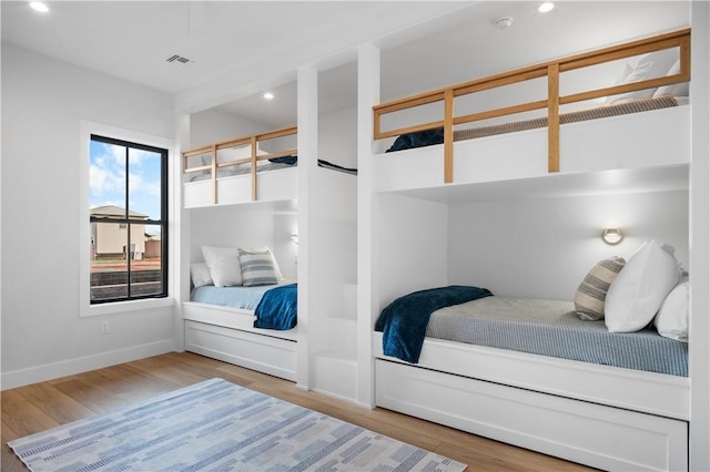 bedroom featuring recessed lighting, visible vents, baseboards, and wood finished floors