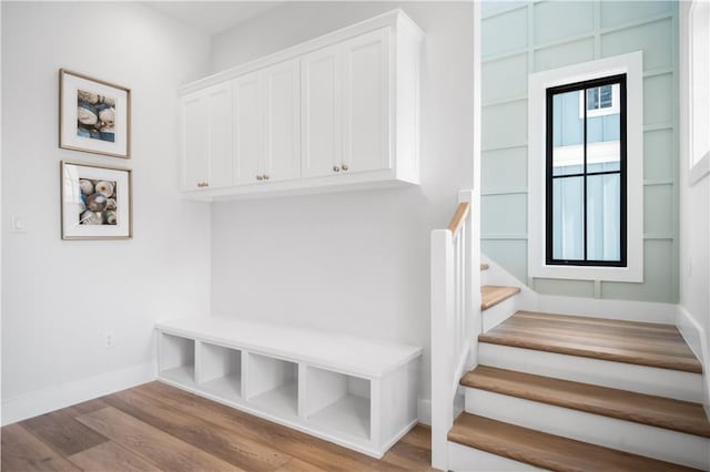 mudroom featuring baseboards and wood finished floors