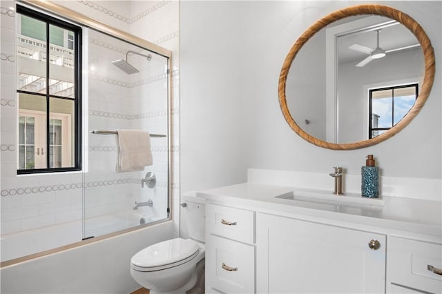 full bath with combined bath / shower with glass door, vanity, and toilet