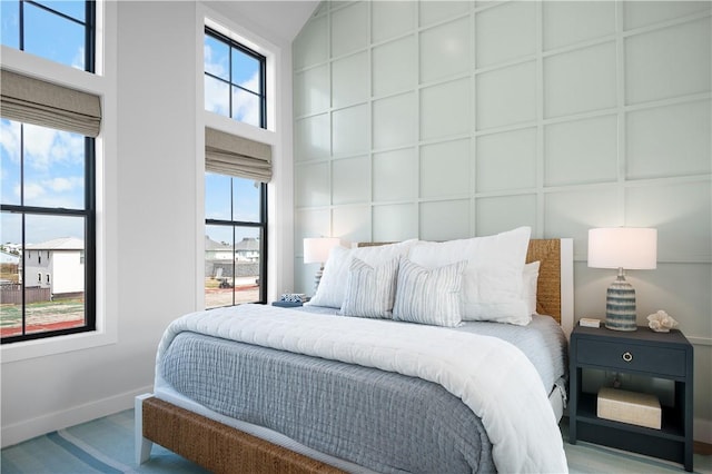 bedroom with a towering ceiling and baseboards