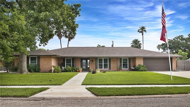 single story home with a garage and a front yard