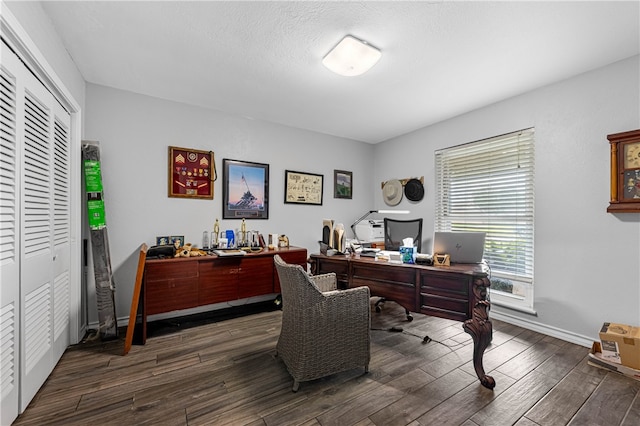 home office with dark hardwood / wood-style floors