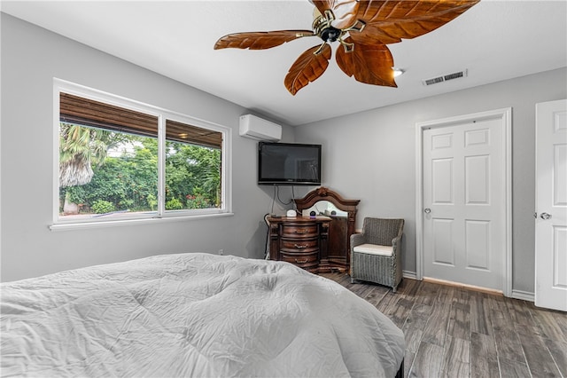 bedroom featuring ceiling fan, dark hardwood / wood-style flooring, and a wall mounted air conditioner