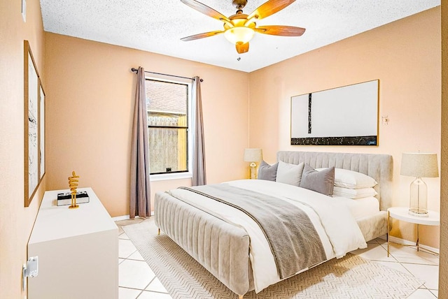 bedroom featuring light tile patterned flooring, a textured ceiling, and ceiling fan