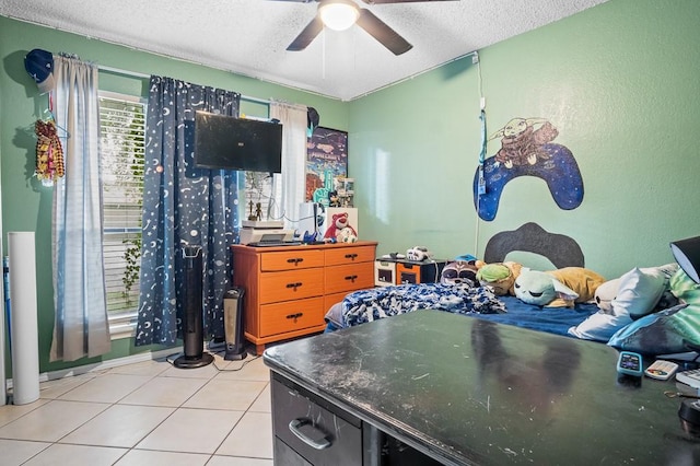 tiled bedroom featuring ceiling fan and a textured ceiling