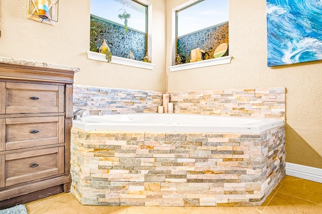 bathroom with a bathtub and tile patterned floors