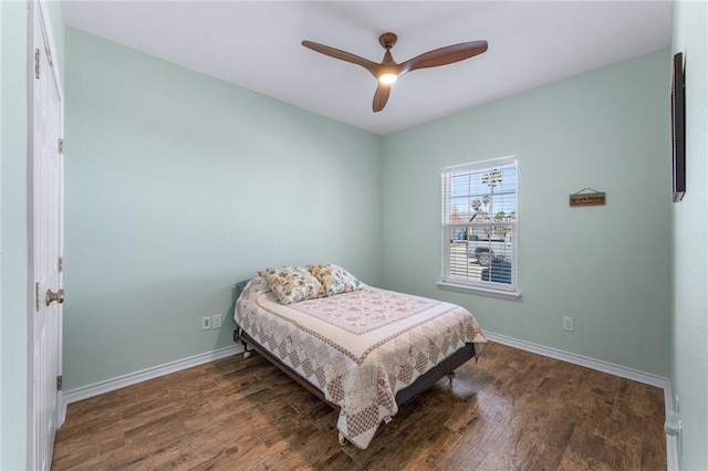 bedroom featuring wood finished floors, a ceiling fan, and baseboards