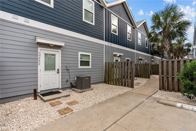 doorway to property featuring a patio area and cooling unit