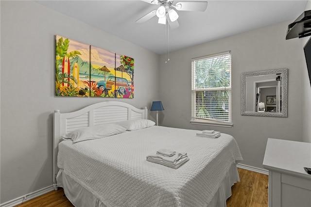 bedroom with wood-type flooring and ceiling fan