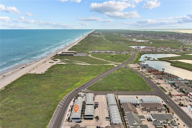 birds eye view of property with a view of the beach and a water view