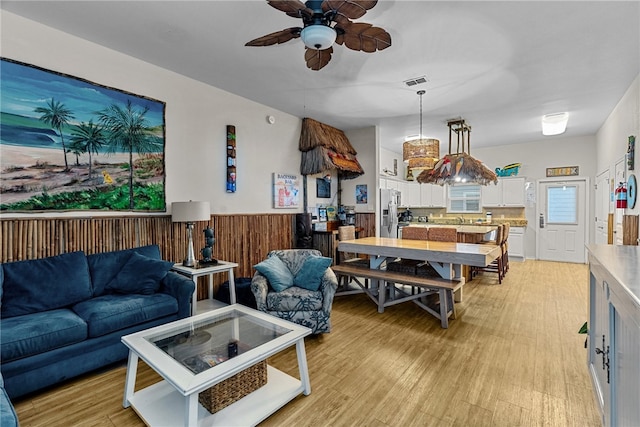 living room featuring ceiling fan and light hardwood / wood-style flooring