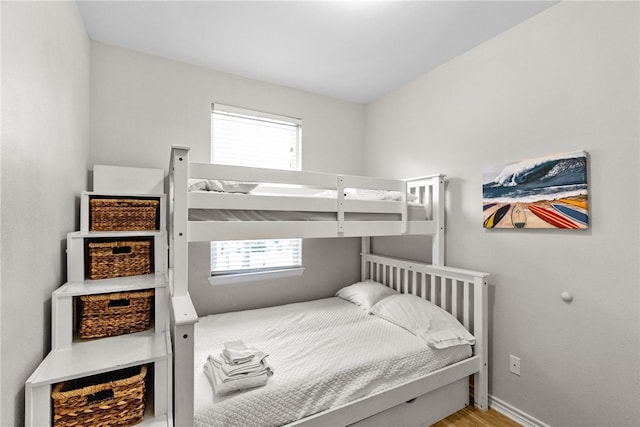 bedroom featuring multiple windows and light hardwood / wood-style flooring