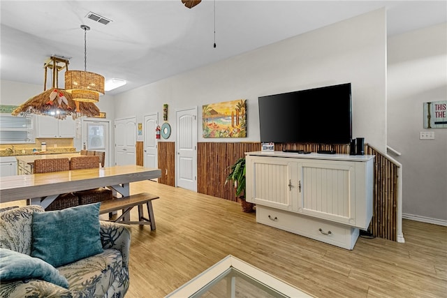 living room featuring light hardwood / wood-style floors and a chandelier