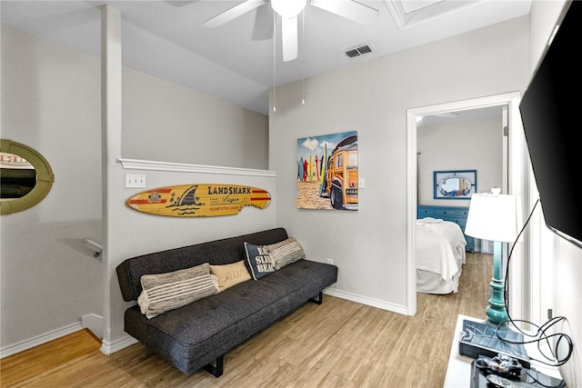 living area featuring ceiling fan and light hardwood / wood-style flooring