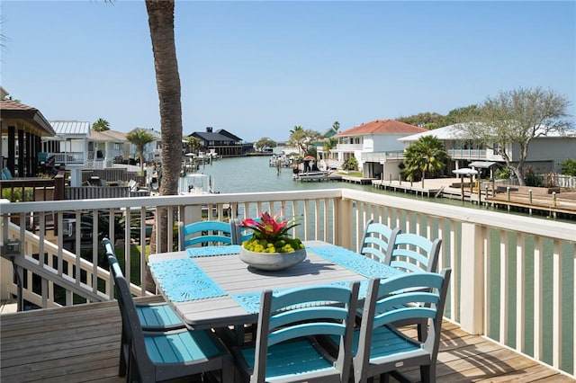 wooden terrace featuring a water view and a residential view