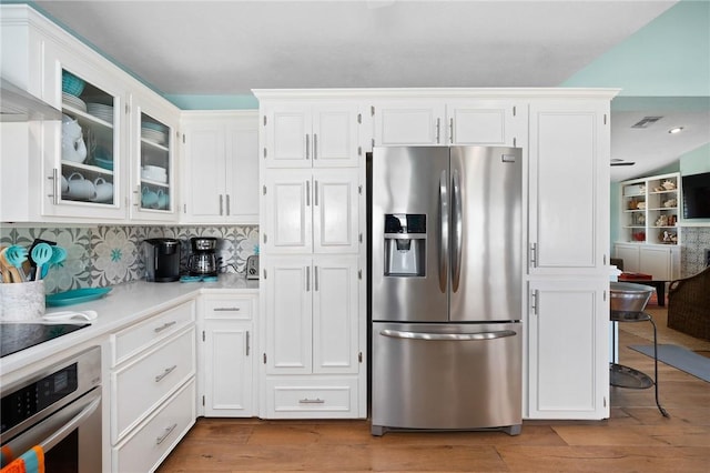 kitchen featuring white cabinets, stainless steel appliances, and light countertops